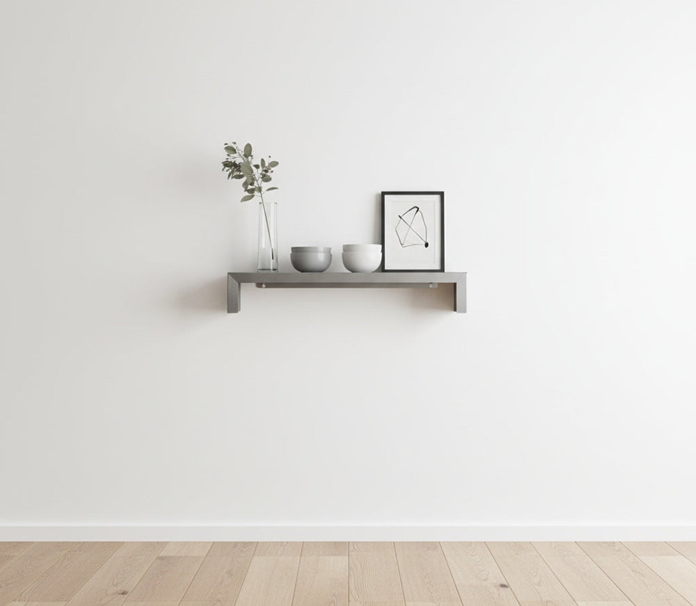 SmartSpan custom-width stainless steel shelf by Fig & Forge installed in a minimalist living room, styled with neutral decor for an architectural look