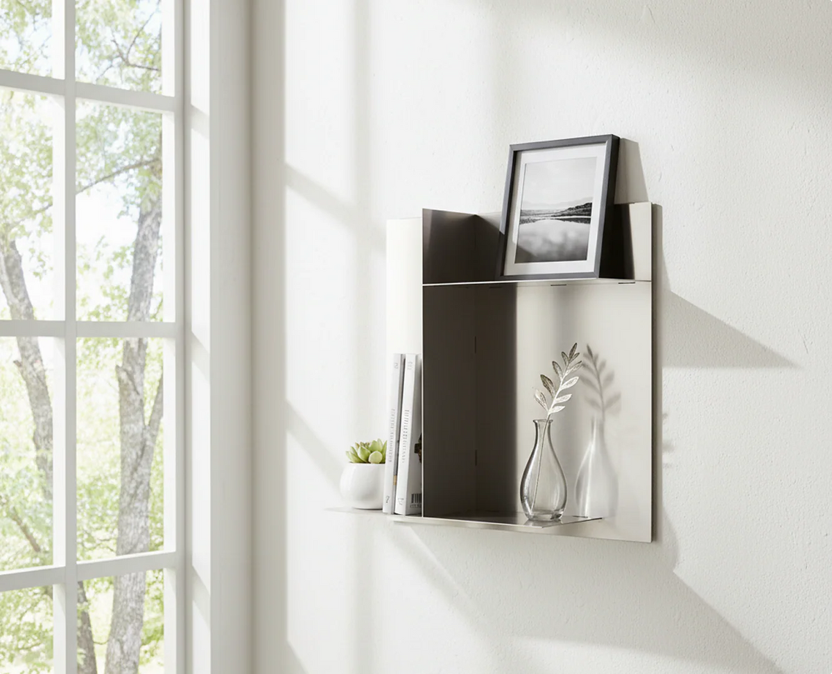 Bespoke stainless steel panel display shelf by Fig & Forge styled with books and minimalist decor, featuring asymmetric storage zones for a modern interior