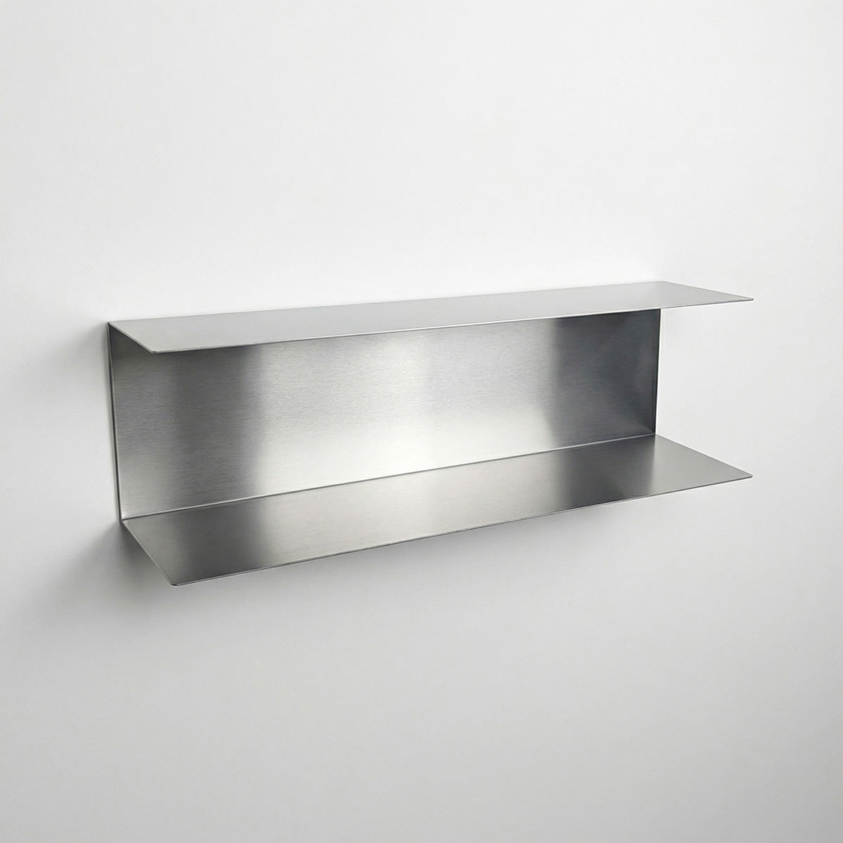 Bespoke dual-level stainless steel wall shelf by Fig & Forge, showing the deep-set design for maximizing vertical storage in modern interiors