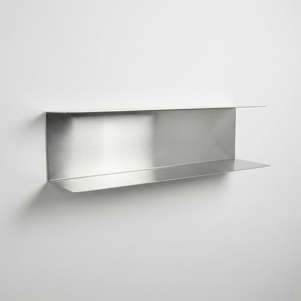 Perspective view of a custom-length stainless steel two-tier floating shelf by Fig & Forge, showing the precision-engineered minimalist profile