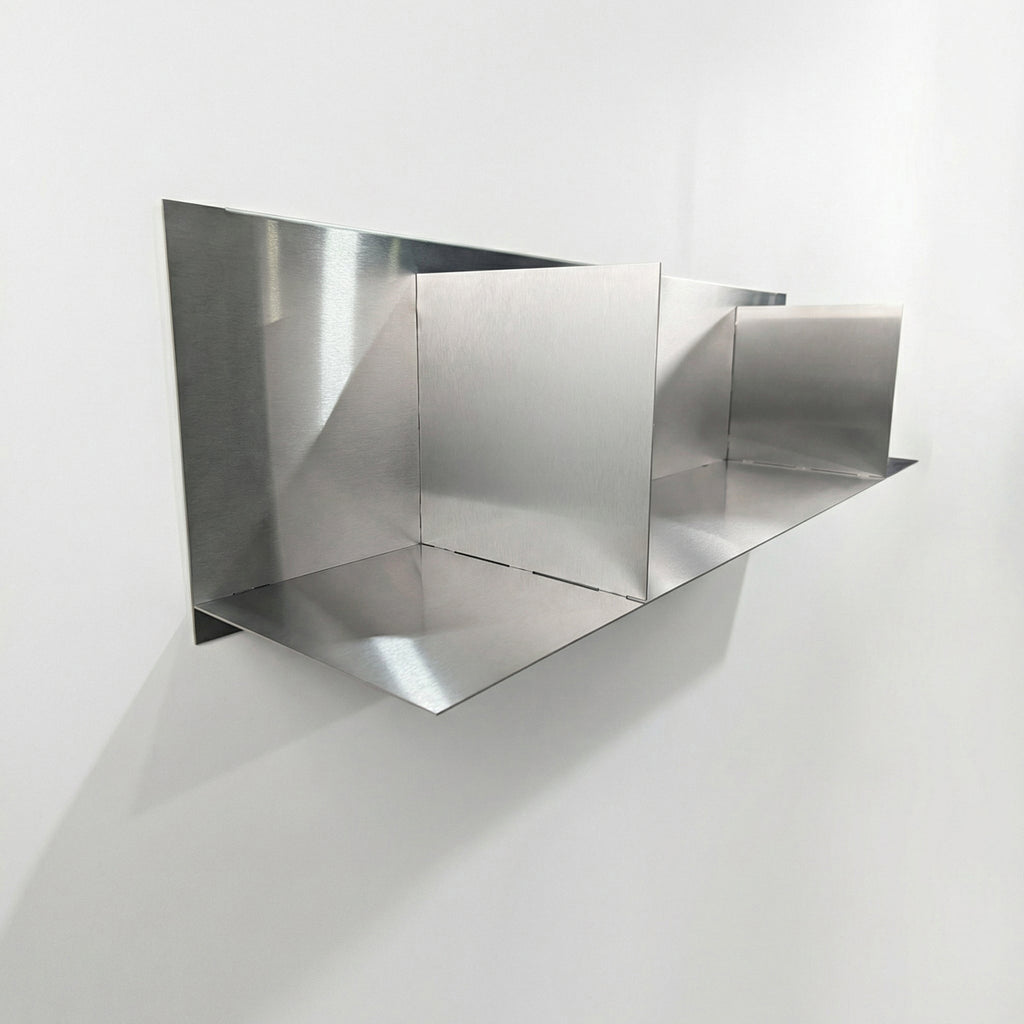 Side-angle view of a heavy-duty stainless steel divider floating shelf by Fig & Forge, highlighting the seamless industrial finish and low-profile wall mounting