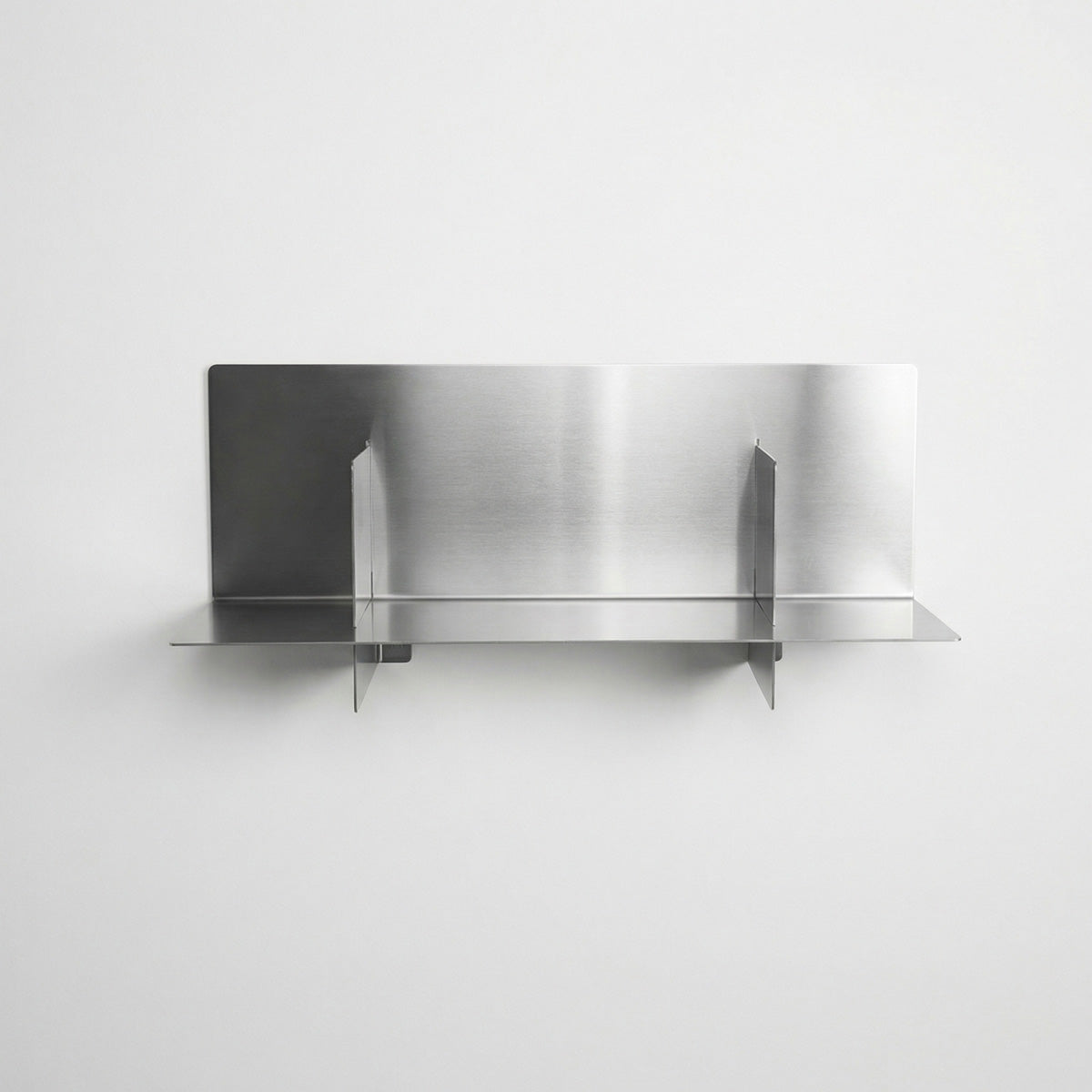 Front view of a custom-length Axis stainless steel shelf by Fig & Forge, demonstrating the symmetrical vertical dividers and sleek industrial floating mount