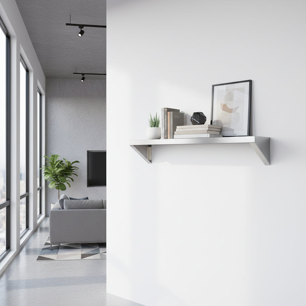 Custom stainless steel Vector shelf by Fig & Forge with angled support gussets, styled as a minimalist bookshelf in a bright modern apartment