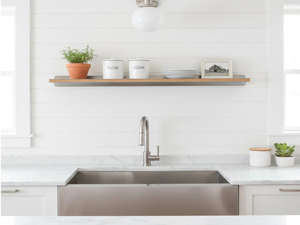 Custom wood-inlay floating shelf in stainless steel by Fig & Forge installed above a kitchen sink for a seamless modern farmhouse aesthetic