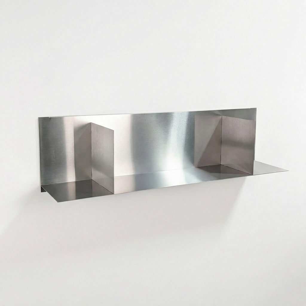 Front perspective of a custom-cut brushed stainless steel divider shelf by Fig & Forge, showing the precision-welded vertical partitions for organized wall storage