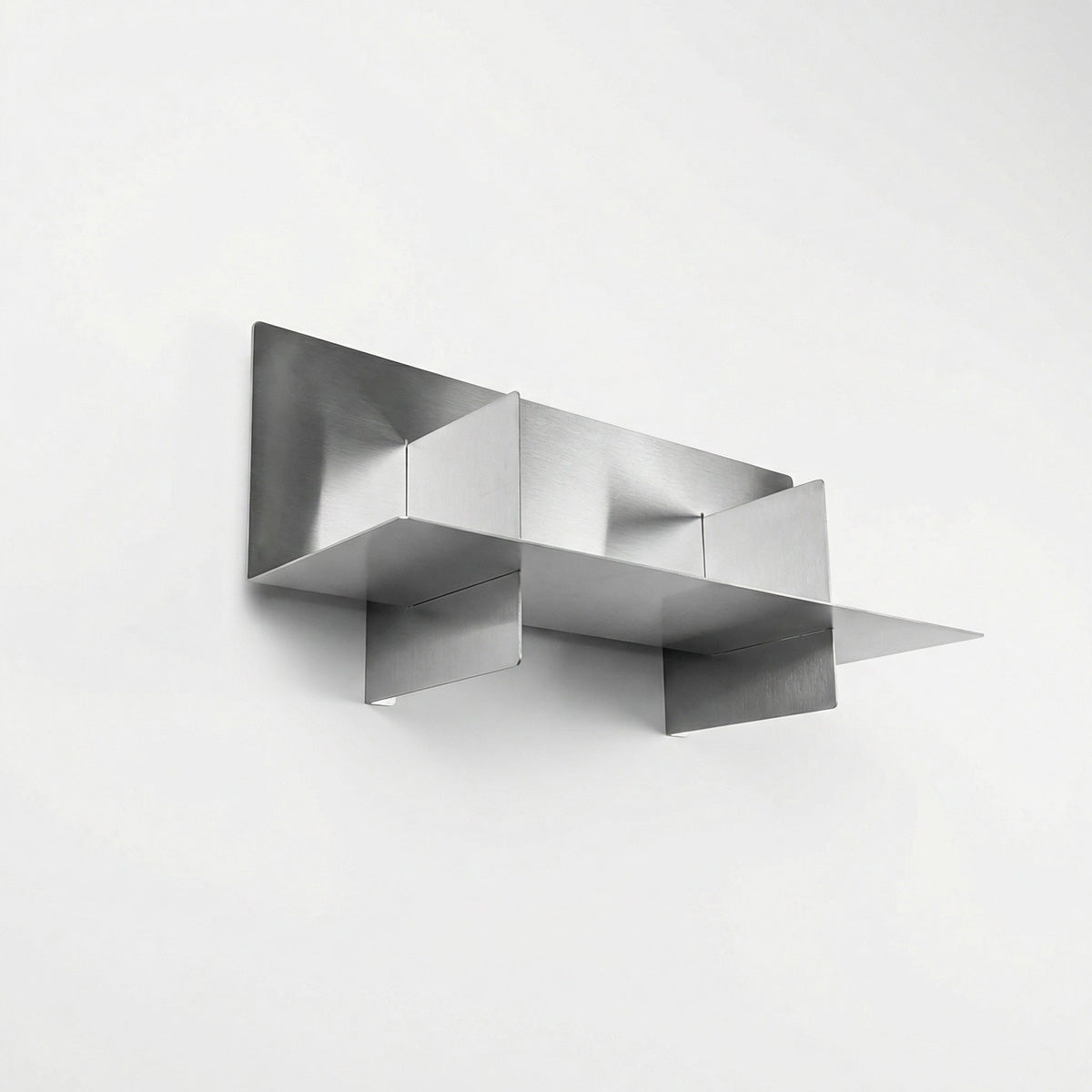 Upward architectural angle of the Fig & Forge Axis shelf, showcasing the intersecting panel design and pre-drilled holes for a secure, flush wall mount